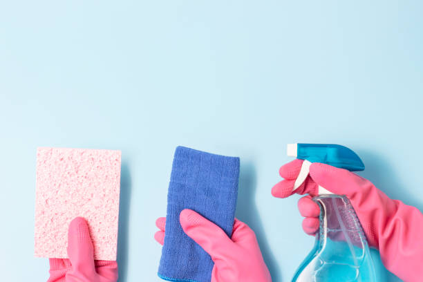 istock Three female hands holding spray bottle and rags, Spring cleaning concert. 1201343962