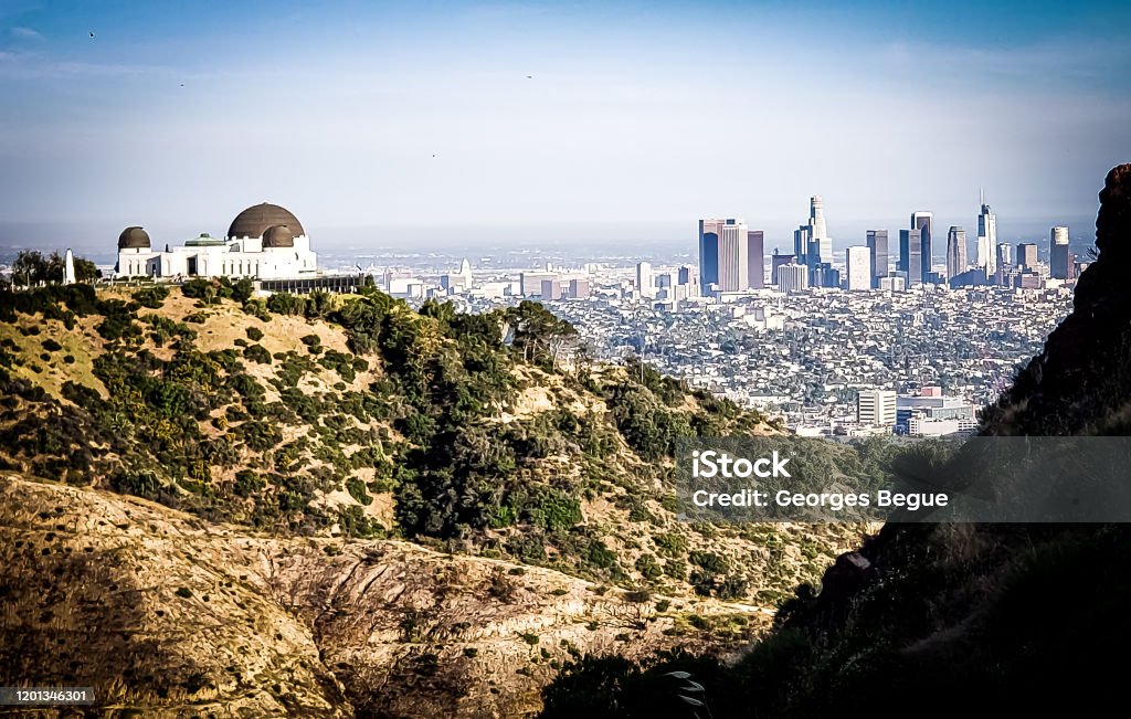 Hollywood hills trail Panoramic view of Downtown Los Angeles and Griffith Observatory from the Hollywood Hills. Los Angeles County Stock Photo