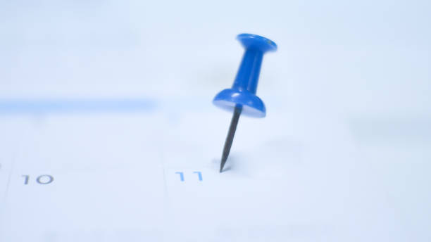 istock Close up  blue pin marking on calendar planning concept with blue tone. 1201346362