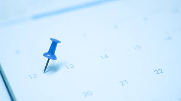 istock Close up  blue pin marking on calendar planning concept with blue tone. 1201346368