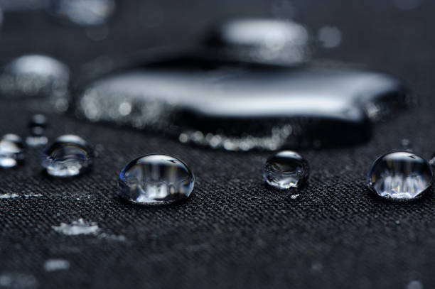 Water Drops on Waterproof Fabric Macro Macro of water drops on black waterproof fabric water repellent stock pictures, royalty-free photos & images