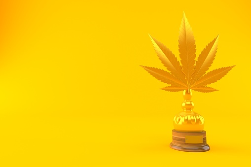 Cannabis leaf golden trophy isolated on orange background. 3d illustration
