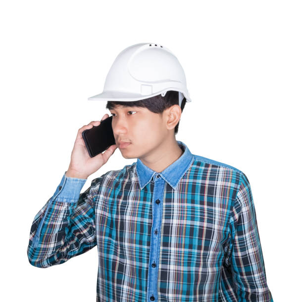 istock Businessman engineer thinking  command with cell phone and wear white safety helmet plastic on white background. construction concept 1201356768