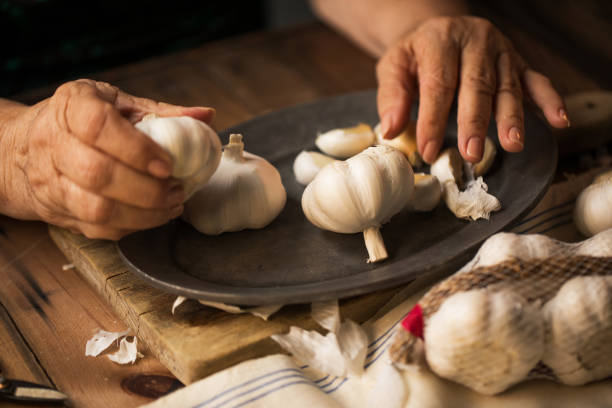 istock Senior woman prepping garlic 1201363159
