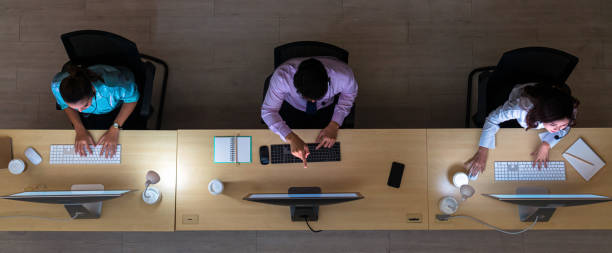 top view of asian customer care service working hard late in night shift at office
top view of asian customer care service working hard late in night shift at office - effort dark concepts women imagens e fotografias de stock