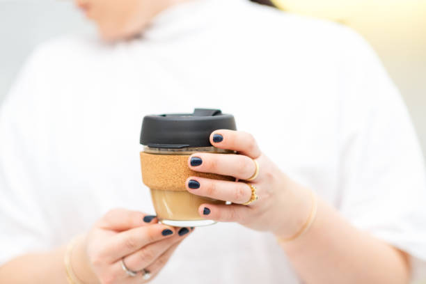 istock Faceless woman holding reusable takeaway glass coffee cup. 1201366533