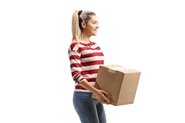 istock Casual young woman carrying a box 1201366554