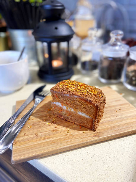 Chocolate cake, a piece of cake with curd cream and carrots on a wooden board. Cafe Style Concept