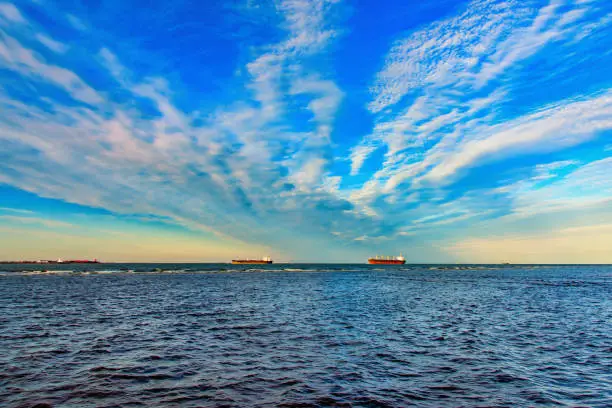 Several large oil tankers entering Galveston Bay at the Gulf of Mexico on route to refineries along the Texas coastline near Houston.