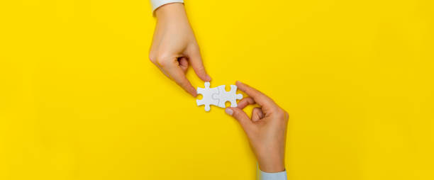 hands with puzzle pieces - unity ideas gear concepts imagens e fotografias de stock