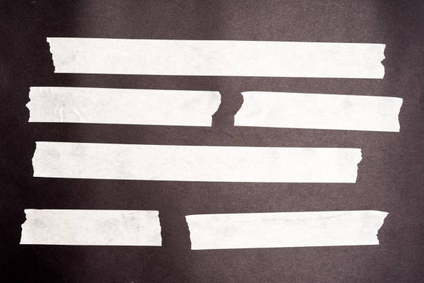 istock Set of white scotch tapes on black background. Torn horizontal and different size white sticky tape, adhesive pieces. 1201367584