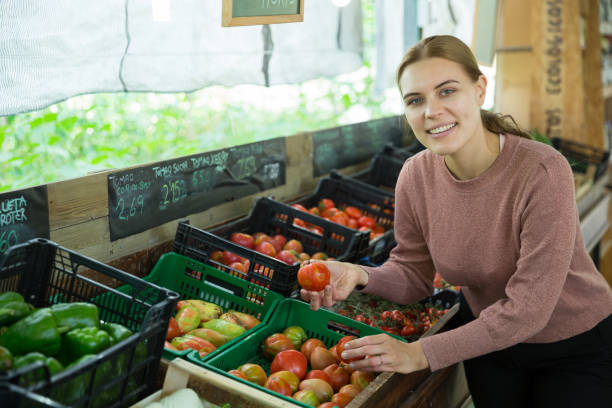 istock Woman choosing tomatoes in grocery store 1201372403