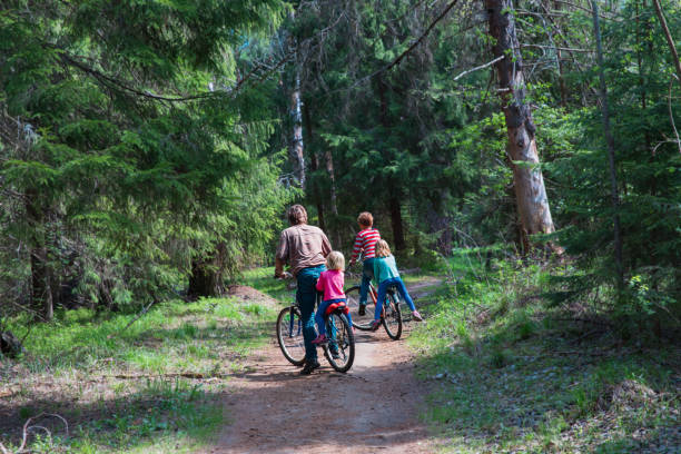 istock father with kids riding bikes in nature 1201372601