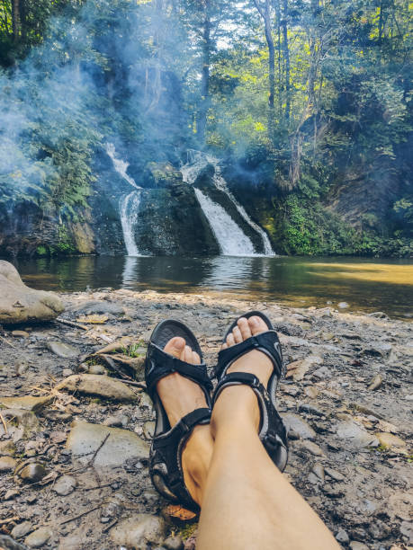 istock hiking concept woman laying with view at waterfall 1201373713