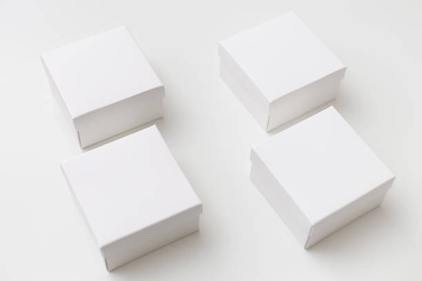 istock Mock up of four same size white boxes on the white background 1201374406