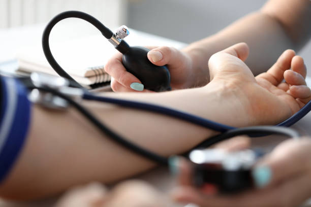 istock Nurse measuring pressure to ill man 1201380756