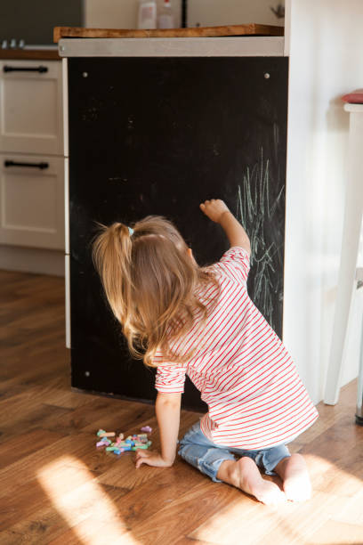 istock little girl drawing with chalks 1201383259