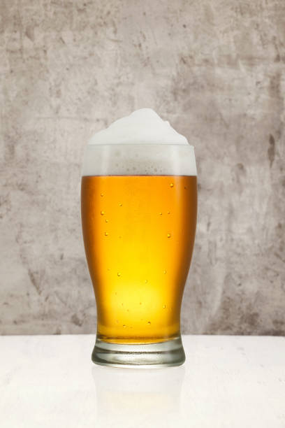 istock Beer splash in glass on vintage background with copy space 1201383683