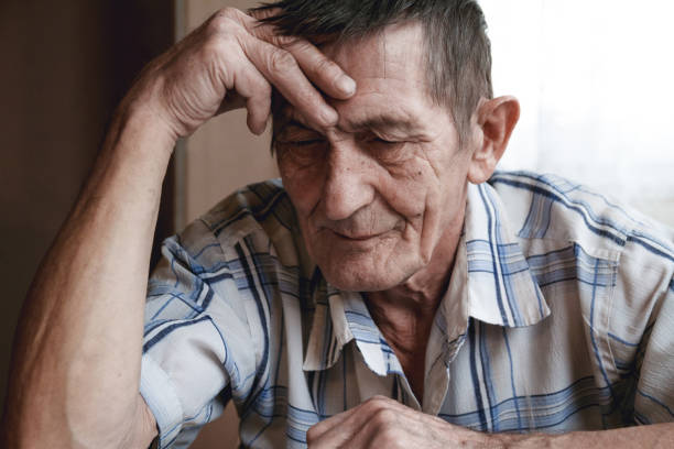 istock Senior sitting at the table and thinking about something or forg 1201387113