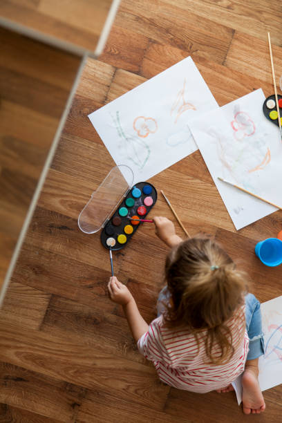 istock little girl painting 1201388343