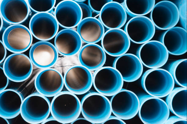 istock Blue plastic pipes used in construction site.Blue PVC water pipe in storage.Packaged blue plastic water pipes at warehouse. 1201388997
