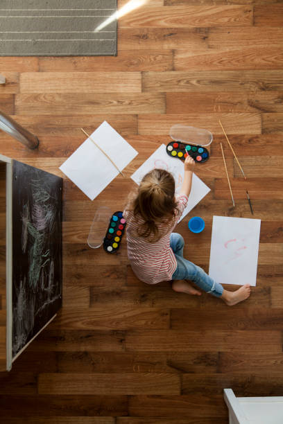 istock little girl painting 1201389034