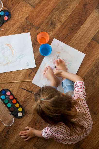 istock little girl painting 1201389839