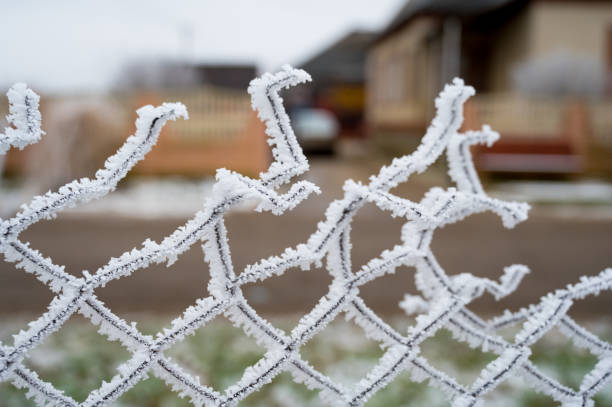 istock Fence covered with hoarfrost on a frosty winter day 1201389952