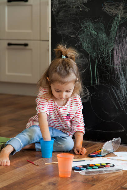 istock little girl painting 1201390802