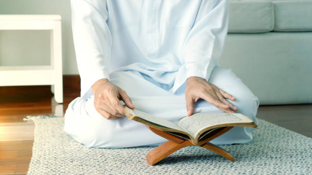 Asian Muslim Man Woman Praying and Prostrating at Home stock photo