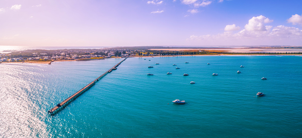 Beachport jetty and moored boats in South Australia at sunset - aerial panorama
