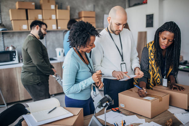 istock Diverse group of people arranging customers orders for drop shipping 1201395321