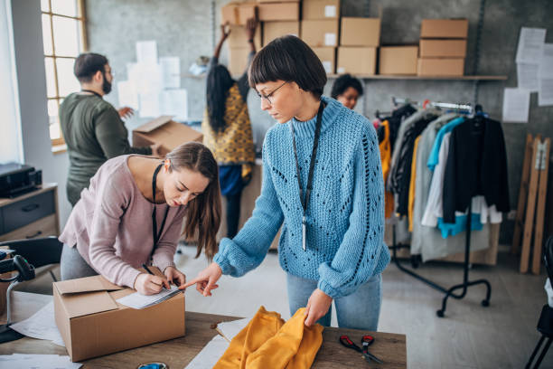 istock Diverse group of people arranging customers orders for drop shipping 1201395371