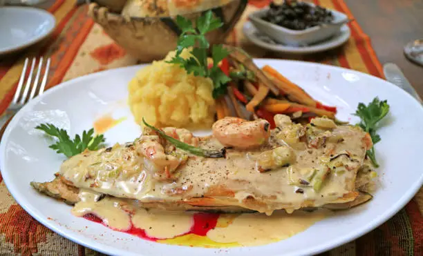 Closeup Mouthwatering Pan-seared Lake Trout with Creamy Shrimp Sauce