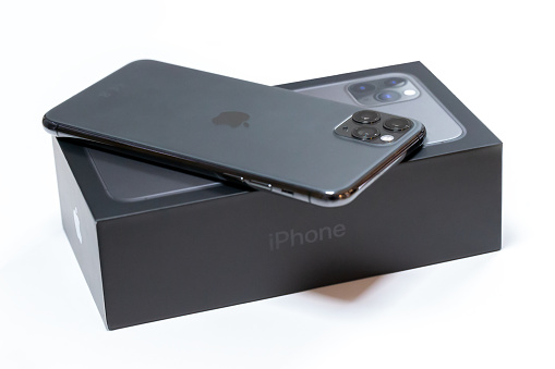 Belgrade, Serbia - January 15, 2020: New Apple iPhone 11 Pro Max mobile smartphone is displayed from rear side on original cardboard box isolated on white background.