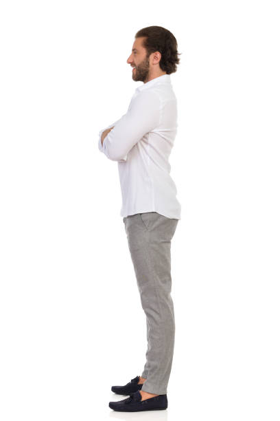 istock Handsome Man Is Standing With Arms Crossed And Looking Away. Side View. 1201397563