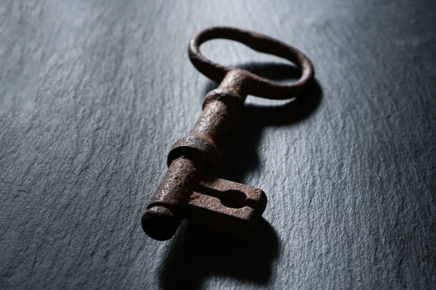 istock old rusty key from an old padlock lies on a black background 1201398199