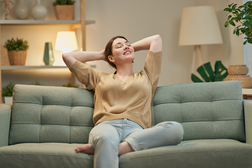 Portrait of beautiful woman resting on sofa at home