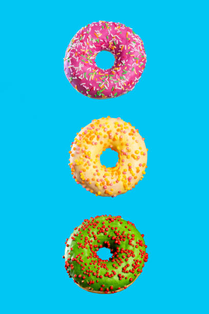 istock donuts on a uniform background hang in the air. six donuts 1201403872