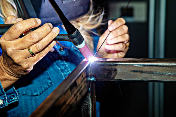 istock Female TIG welder 1201405259