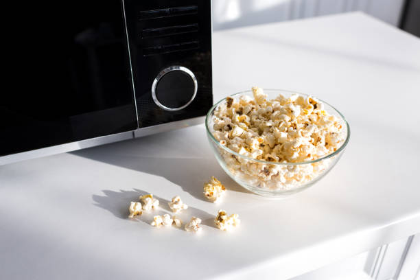 istock popcorn in bowl near microwave on table in kitchen 1201405306