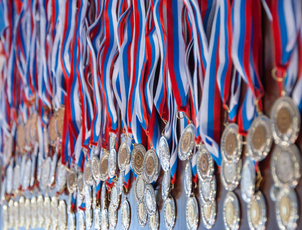 a lot of gold medals with ribbons - gold medal audio imagens e fotografias de stock