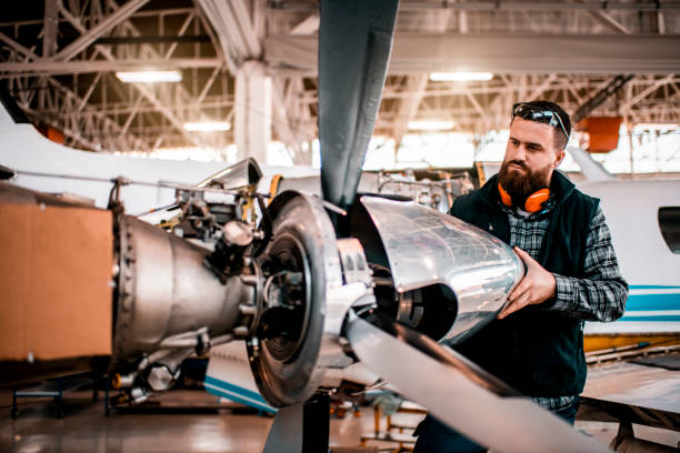 istock Airplane engineer working on a propeller assembly of an aircraft engine in a maintenance hangar 1201406066
