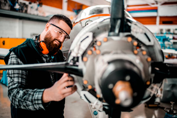 istock Aircraft engineer repairing a small front-engine airplane disassembled in a hangar 1201406995
