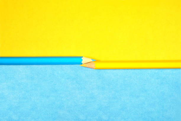 istock School beginnings. yellow and blue pencils on two tones paper background. two multicolored pens, top view close up. Office and back to school projects. 1201407083