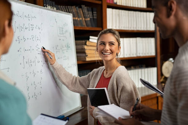 happy student writing exercise on whiteboard - whiteboard education school university imagens e fotografias de stock