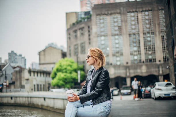 istock One beautiful young woman sitting by the river 1201407140