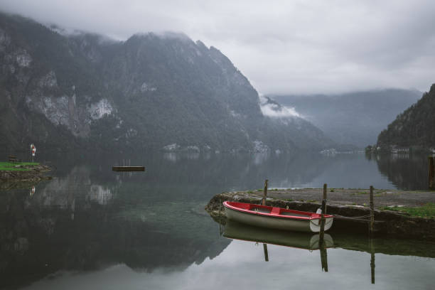 istock Traunsee lake. Wooden bridge and a boat between mountains 1201407581
