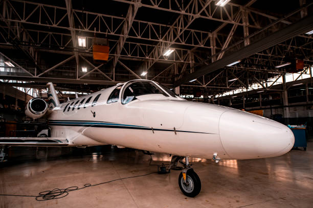 istock Small dual-motor airplane stored in an aircraft hangar 1201407611