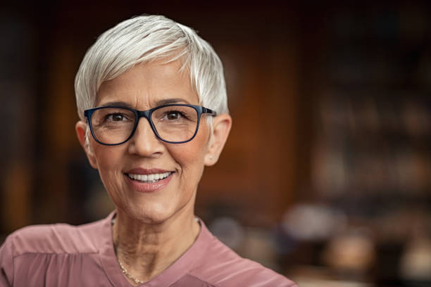 happy beautiful senior woman smiling - professor library librarian university imagens e fotografias de stock